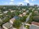 Expansive aerial view showcasing a residential area near the city with lush trees and a water view at 3501 W Tacon St, Tampa, FL 33629