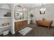 Spacious bathroom with a copper soaking tub, vanity with double sinks, and glass shower at 3501 W Tacon St, Tampa, FL 33629