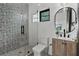 Stylish bathroom features patterned tile, a glass-enclosed shower, and a modern vanity with sleek fixtures at 3501 W Tacon St, Tampa, FL 33629