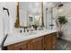 Elegant bathroom features double vanity with an ornate gold trimmed mirror and a glass enclosed shower with rainfall showerhead at 3501 W Tacon St, Tampa, FL 33629