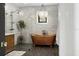 Bathroom showcasing a copper soaking tub under a chandelier, tiled walls and glass enclosed shower at 3501 W Tacon St, Tampa, FL 33629
