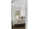 Bedroom showcasing patterned wallpaper, a black framed window and contemporary light fixture at 3501 W Tacon St, Tampa, FL 33629
