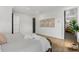 Spacious bedroom with hardwood floors, modern trim, and stylish decor with doorway to en suite bathroom at 3501 W Tacon St, Tampa, FL 33629