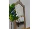 Charming bedroom with a patterned wallpaper viewed through a mirror and a leafy plant at 3501 W Tacon St, Tampa, FL 33629
