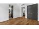 Bedroom with hardwood floors featuring doorways leading to a bathroom and hall at 3501 W Tacon St, Tampa, FL 33629