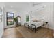 Spacious bedroom with wood floors, black frame windows, patterned walls, and a jute rug at 3501 W Tacon St, Tampa, FL 33629