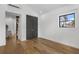 Bedroom with hardwood floors, built-in closet, and bright natural light at 3501 W Tacon St, Tampa, FL 33629