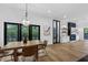 Inviting dining room with modern lighting and access to the back yard through black-framed glass doors at 3501 W Tacon St, Tampa, FL 33629