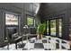 Elegant foyer with black and white checkered floors, statement walls, and a view to the front yard at 3501 W Tacon St, Tampa, FL 33629