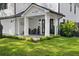 Inviting front porch with comfortable seating and lush landscaping, with brick and white columns at 3501 W Tacon St, Tampa, FL 33629