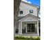 Stunning front porch with brick and white columns, with black trimmed windows and doors at 3501 W Tacon St, Tampa, FL 33629