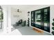 Cozy front porch with seating, modern light fixture, and a welcoming 
