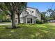 Charming two-story home with a green lawn, manicured landscaping, and a modern design at 3501 W Tacon St, Tampa, FL 33629