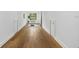 Hardwood hallway features a window, yoga mat, and minimalist decor at 3501 W Tacon St, Tampa, FL 33629
