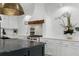 Kitchen design features a white range hood, floating shelves, and custom cabinets at 3501 W Tacon St, Tampa, FL 33629