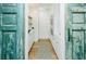 Charming butler's pantry features wooden floors, white cabinets, and unique turquoise distressed doors at 3501 W Tacon St, Tampa, FL 33629