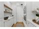 Stylish butler's pantry features white cabinets, wooden floors, stainless steel oven, and floating shelves at 3501 W Tacon St, Tampa, FL 33629