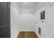 Bright laundry room features hardwood floors, storage shelf, and laundry-themed decor at 3501 W Tacon St, Tampa, FL 33629