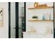 Bright room includes wooden shelves, custom wine storage, and black-framed doors to additional room at 3501 W Tacon St, Tampa, FL 33629