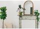 Close-up on a charming mantelpiece with plants and an arched mirror in a well-lit living space at 3501 W Tacon St, Tampa, FL 33629