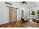 Bright living area featuring hardwood floors, stylish seating, barn door and black frame windows at 3501 W Tacon St, Tampa, FL 33629