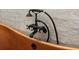 Close up of elegant tub faucet and copper soaking tub against a bright, tiled wall at 3501 W Tacon St, Tampa, FL 33629