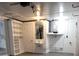 Finished basement with storage, a sink, a door to the backyard, and the home's water heater at 3601 Grayton Dr, New Port Richey, FL 34652