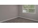 Bedroom view of vinyl floors, window and light gray walls at 3601 Grayton Dr, New Port Richey, FL 34652