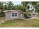 Charming one-story home with neutral stucco, white trim, and complemented by landscaped front yard at 3601 Grayton Dr, New Port Richey, FL 34652