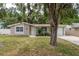 Charming single-story home with a well-maintained front yard and mature landscaping and attached garage at 3601 Grayton Dr, New Port Richey, FL 34652