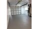 Clean garage with an automatic door opener, painted floor, and a utility sink at 3601 Grayton Dr, New Port Richey, FL 34652