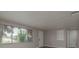 Living room featuring new gray wood-look flooring and lots of natural light at 3601 Grayton Dr, New Port Richey, FL 34652