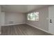 Bright living room featuring new gray wood-look flooring and lots of natural light at 3601 Grayton Dr, New Port Richey, FL 34652