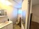 A simple bathroom with neutral walls and tile floor with a small mirror and sink at 37135 Sandra Ave, Zephyrhills, FL 33542