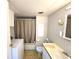 Well-lit bathroom with a combined shower and washer machine at 37135 Sandra Ave, Zephyrhills, FL 33542
