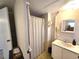 A simple bathroom featuring a sink with a mirror and shower with a curtain at 37135 Sandra Ave, Zephyrhills, FL 33542