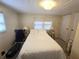 Cozy bedroom featuring a comfortable bed, soft lighting, and neutral decor at 37135 Sandra Ave, Zephyrhills, FL 33542