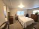 A calm bedroom features warm lighting and furniture and neutral décor at 37135 Sandra Ave, Zephyrhills, FL 33542