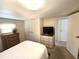 Well-lit bedroom with closet and dresser and neutral carpet at 37135 Sandra Ave, Zephyrhills, FL 33542