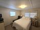 Bright bedroom with a comfortable bed, soft lamps, and neutral-toned walls at 37135 Sandra Ave, Zephyrhills, FL 33542