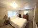 Cozy bedroom featuring warm lighting and closet with neutral color decor at 37135 Sandra Ave, Zephyrhills, FL 33542