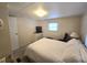 Well-lit bedroom features a comfortable bed with closet space and neutral carpet at 37135 Sandra Ave, Zephyrhills, FL 33542