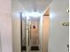 Hallway with mirrors and access to multiple rooms in the house at 37135 Sandra Ave, Zephyrhills, FL 33542