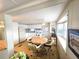 Well-lit kitchen area featuring bright white cabinetry, complementary appliances, and a cozy dining table with comfortable seating at 37135 Sandra Ave, Zephyrhills, FL 33542