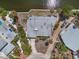 Aerial view displays home featuring mature landscaping and canal access at 396 Avenida Madera, Sarasota, FL 34242