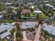 Aerial view shows a lovely home with a driveway and mature landscaping bordering a canal at 396 Avenida Madera, Sarasota, FL 34242