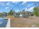 Backyard view with wooden deck and waterside seating, offering a serene outdoor living space at 396 Avenida Madera, Sarasota, FL 34242