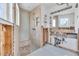Bathroom with tiled shower and pebbled floor, awaiting remodeling completion at 396 Avenida Madera, Sarasota, FL 34242