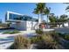 Modern Siesta Beach building with architectural lines, surrounded by lush greenery and palm trees at 396 Avenida Madera, Sarasota, FL 34242
