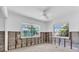Bedroom with tile flooring, ceiling fan and two windows with lovely views awaiting remodeling completion at 396 Avenida Madera, Sarasota, FL 34242